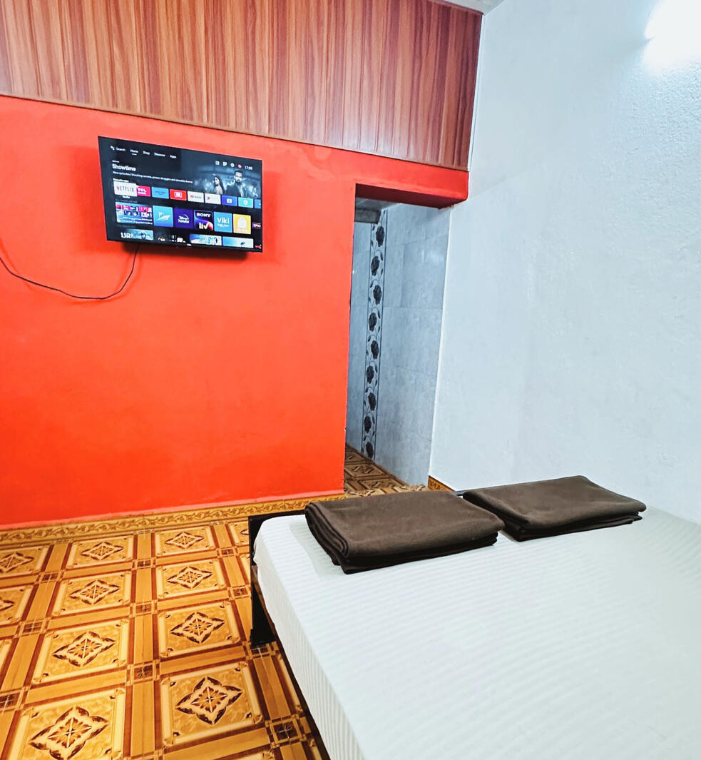 Clean and spacious AC bedroom at Konkan Central Homestay in Kankavli.